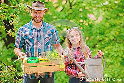 Planting season. Family garden. Maintain garden. Planting flowers. Family dad and daughter planting plants Stock Photo