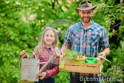 Planting season. Family garden. Maintain garden. Planting flowers. Family dad and daughter planting plants Stock Photo