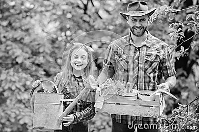 Planting season. Family garden. Maintain garden. Planting flowers. Family dad and daughter planting plants Stock Photo