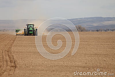 A farmer plants wheat in an Idaho farm field. Editorial Stock Photo