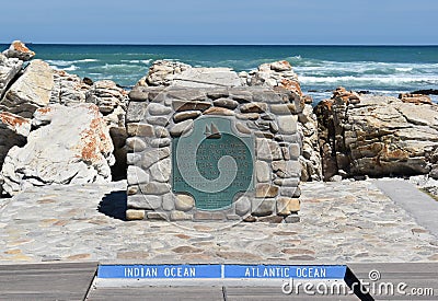 Plaque at southernmost point of Africa against Atlantic Ocean and Indian Ocean at Cape Agulhas Stock Photo