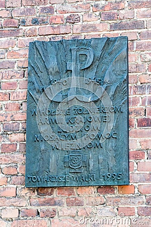 Plaque in tribute to the soldiers of the Home Army and people helping prisoners in Auschwitz concentration camp Editorial Stock Photo