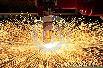 Plasma or laser cutting metalworking with sparks Stock Photo