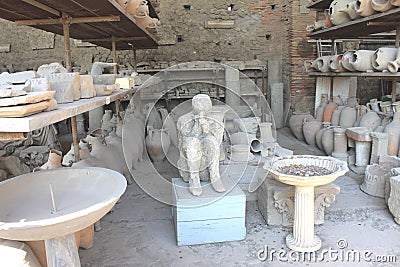 Plaster casts of victim of eruption Mount Vesuvius and ancient pottery in Pompeii - ancient Roman city in Italy. Stock Photo