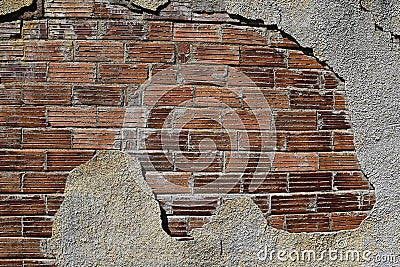 Plaster crumbling exposing bricks Stock Photo
