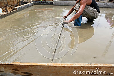 A plasterer concrete worker at floor work Stock Photo