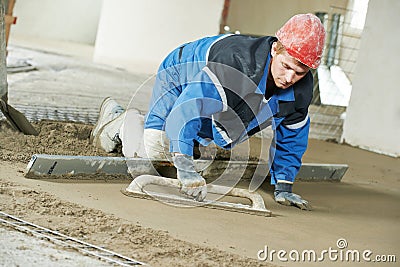 Plasterer concrete worker at floor work Stock Photo