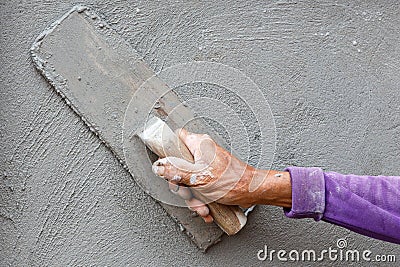 Plasterer concrete worker at wall of house construction Stock Photo