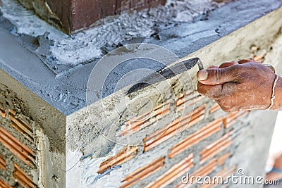 Plasterer concrete worker at wall of house construction Stock Photo