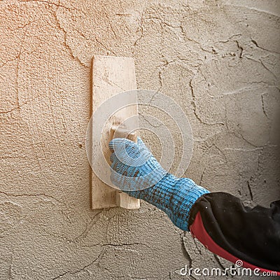 Plasterer concrete worker at wall of house Stock Photo