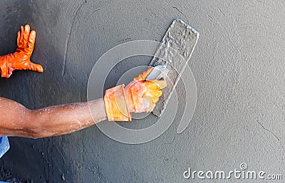 Plasterer concrete worker at wall of house construction Stock Photo