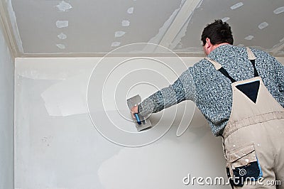 Plasterer or dry waller at work Stock Photo