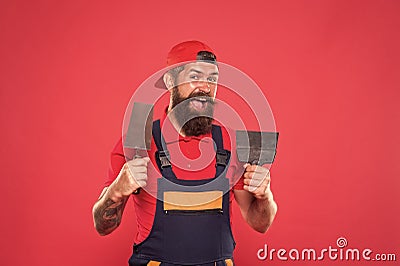 Plasterer hipster builder in cap red background. Interior designer. Bearded man worker with plastering tools Stock Photo