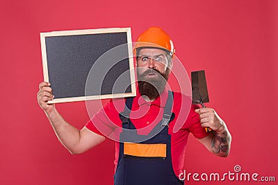 Plasterer hipster builder in hard hat hold blackboard copy space. Professional plasterer. Dreams come true. Skillful Stock Photo