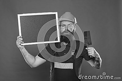 Plasterer hipster builder in hard hat hold blackboard copy space. Professional plasterer. Dreams come true. Skillful Stock Photo