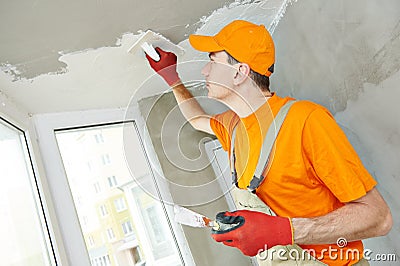 Plasterer at indoor ceiling work Stock Photo