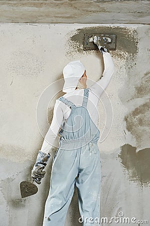 Plasterer at indoor wall work Stock Photo