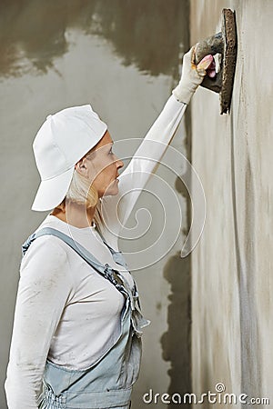 Plasterer at indoor wall work Stock Photo