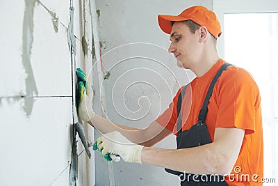 Plasterer installing screed on wall for plastering Stock Photo