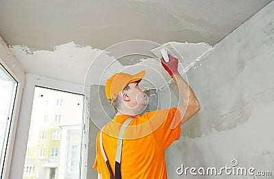 Plasterwork and painting preparation. craftsman applying plaster or filling on ceiling Stock Photo