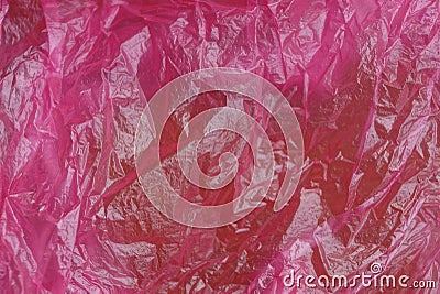 Plastic texture of a piece of crumpled red bright cellophane Stock Photo