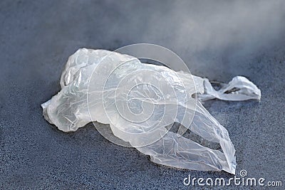 Plastic bag clear on the floor, old plastic bag waste, dirty plastic waste, plastic waste is polluting the environment selective Stock Photo