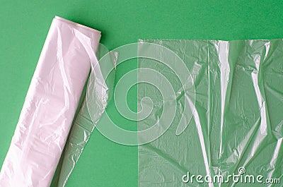 Plastic bag and polyethylene sack roll on green background Stock Photo