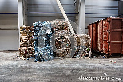 Plastic bales of rubbish at the waste treatment processing plant. Recycling separatee and storage of garbage for further disposal Editorial Stock Photo