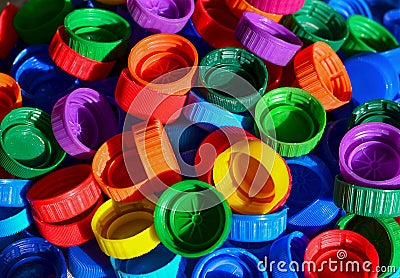 Plastic bottle caps background. Cap material is recyclable.Remove lids from plastic bottles before recycling them. Recycling Stock Photo