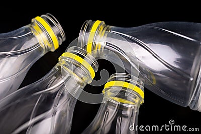 Plastic bottle after a food drink. Disposable packaging on a dark table. Stock Photo