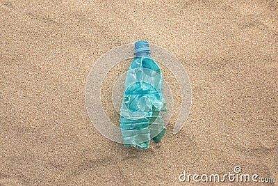 Plastic bottle lies on the beach and pollutes the sea. Spilled garbage on the beach Stock Photo