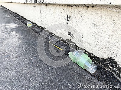 The plastic bottle or plastic glass discard on street Stock Photo