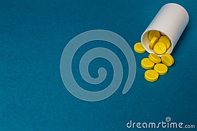 Plastic bottle with yellow pills close up Stock Photo