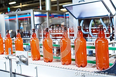 Plastic bottles with beer or carbonated beverage moving on conveyor Stock Photo