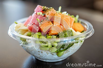 Plastic bowl tasty seafood salad with rice and edamame beans Stock Photo