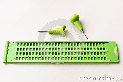 Plastic braille writing slate and stylus Stock Photo