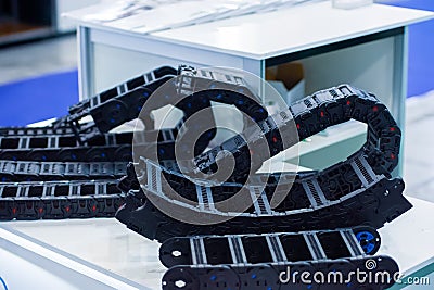 Plastic cable chain of electrical wires in the machine. An example of a cable-laying machine. Flexible cable duct Stock Photo