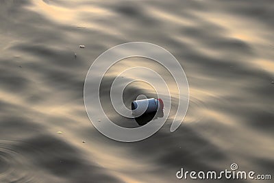 Plastic cans garbage floating on the sewage water Stock Photo