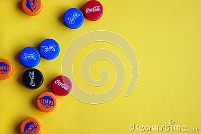 Plastic caps from different drinks soda. Popular brands Coca Cola, Fanta, Sprite Editorial Stock Photo