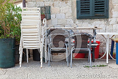 Plastic chairs stacked up broken and unused Stock Photo