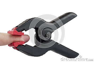 Plastic clamps squeezing finger on a white background Stock Photo