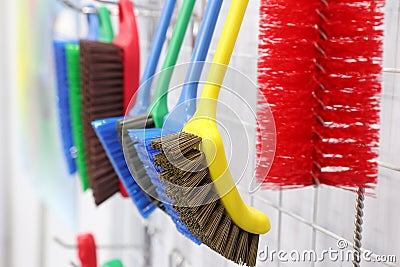 plastic cleaning brushes in supermarket hanger Stock Photo