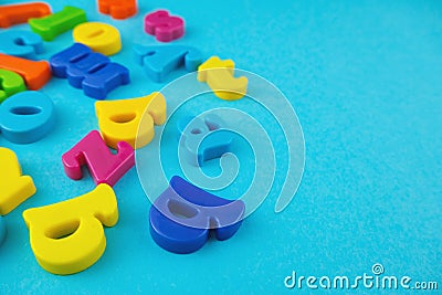 Plastic colourful alphabet letters on the blue background Stock Photo