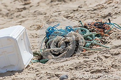 Plastic commercial fishing rope and net pollution on a beach Stock Photo