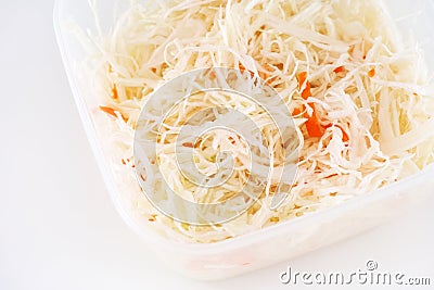 A plastic container full of salad with chopped cabbage and carrot Stock Photo