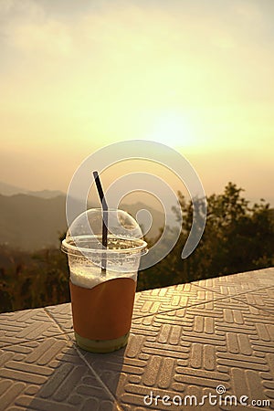 Plastic cup with straw on mountain layers background Stock Photo