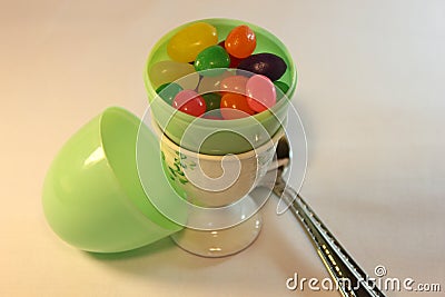 Plastic egg with jelly beans Stock Photo