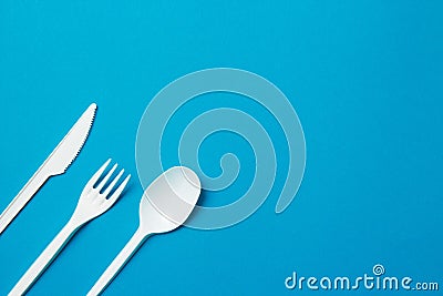 Plastic Fork, Spoon and Knive on Blue Background Stock Photo