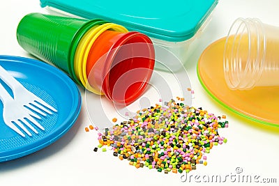 Plastic granules and disposable tableware made of polyethylene, polypropylene polymeric material on a white background. BPA FREE Stock Photo