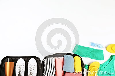 Plastic hardshell suitcase packed with casual clothing items Stock Photo